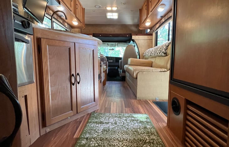 Kitchen with sink, stove, oven, freezer, and fridge. Everything is needed for meals and dining space.