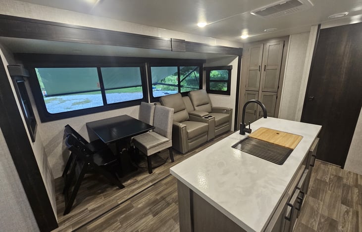 large kitchen with an island, 2 heated recliners with charging ports and built in massage. Kitchen table.