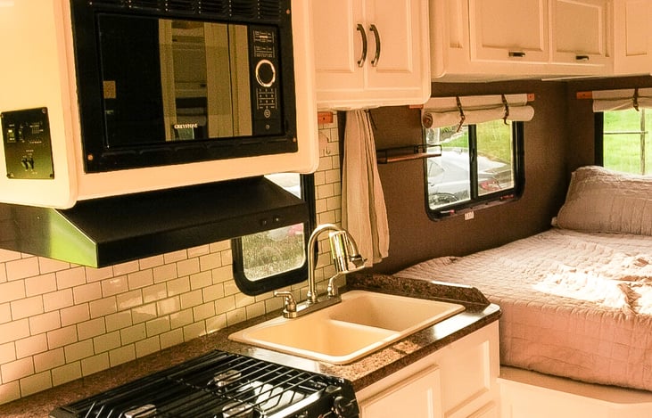 Kitchen and queen bed in the back