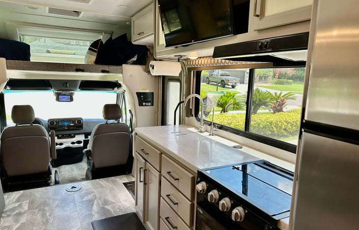 Functional kitchen area with plenty of counter space, there is even an extra counter folded down at the end next to the sink.