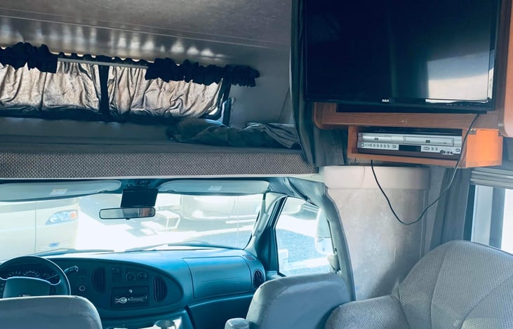 TV and Blu-ray/DVD player for entertainment along with a top bunk for sleeping or extra storage.