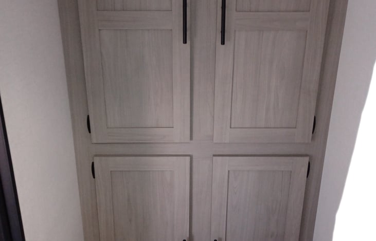 Cupboards in the bathroom. The two upper cupboards provide a rod for hanging clothing etc. Very roomy