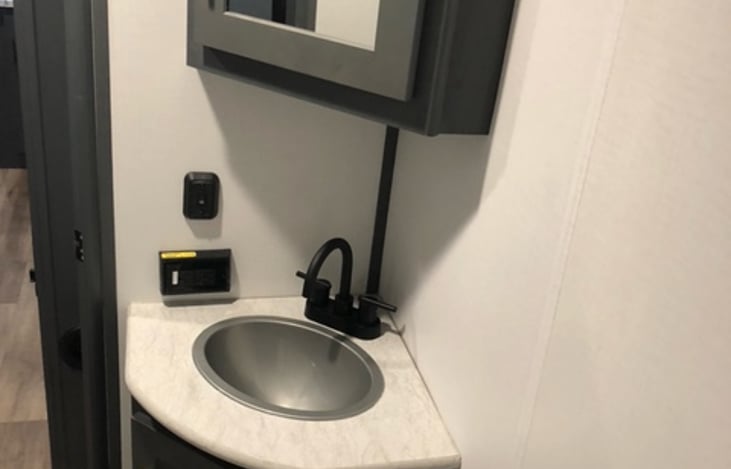 Vanity with storage on top and bottom.