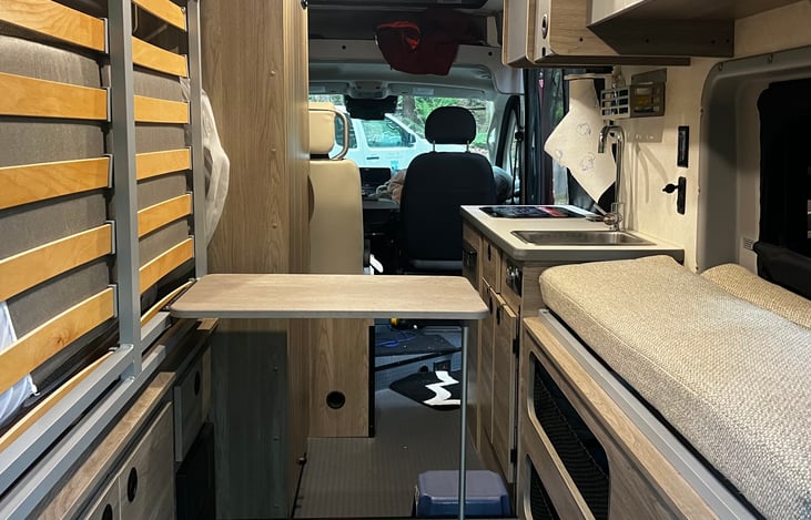 Drop down table can be used as additional counter space. Stores under the Murphy bed.