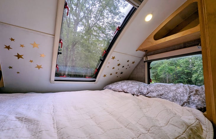 Cozy Queen bed nook with two windows, TV, stereo and storage cubbies will ensure you are comfortable and have everything you need for some rest and relaxation.