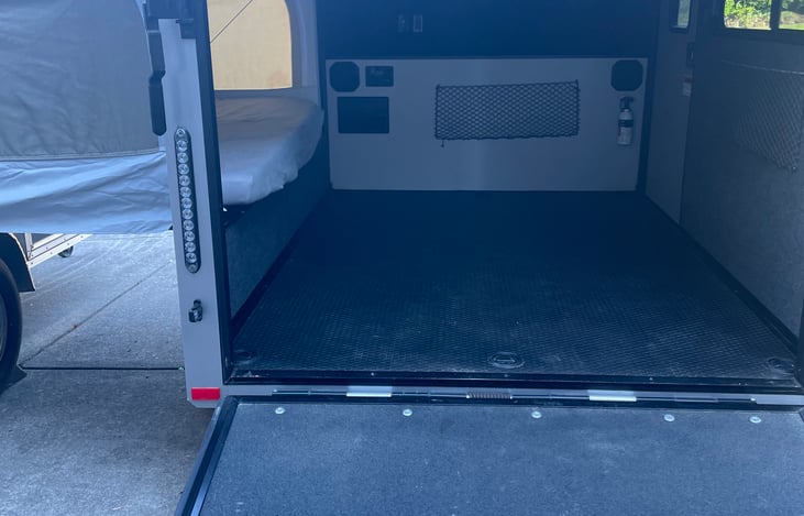 Trailer Inside will be stocked with TV, grill, Two camp chairs, pop up table and bins in the overhead with lables shown in pictures below.