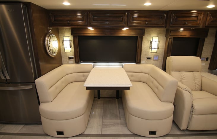 booth dinette with additional seats and table leaf extension in the coach