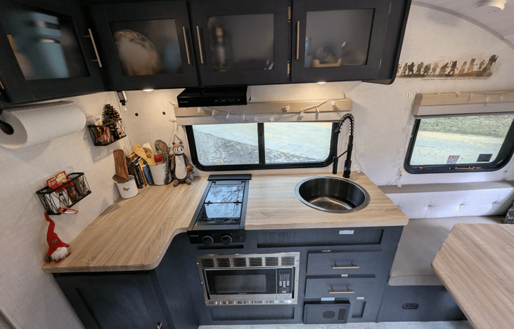 Cozy, modern and bright living area with well-equipped kitchen, TV, large dinette that converts to a bed, pop-out window and whimsical touches throughout.