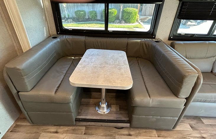 Dinette, table top swivels and converts to a bed.