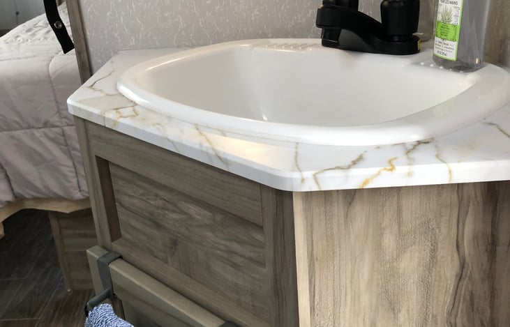 Corner bathroom vanity provides extra space