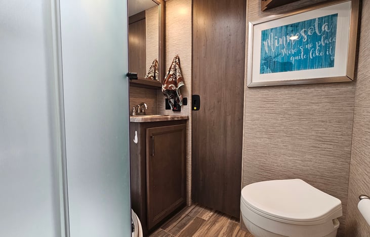 Standard toilet and plenty of storage make this bathroom comfortable without sacrificing valuable floor space.