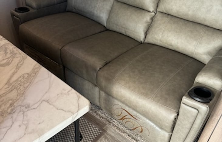 Spacious couch with free standing table.