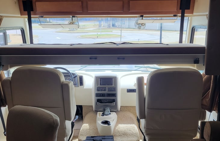 The bed above the front seats is electrically controlled, and the ladder makes it easy for any size person. 80" long so even your tallest family member will be comfy.