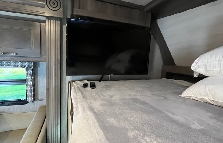 Full Size Bed above Cab with Smart Television with Mounting Bracket that can be watched from Main Living Area