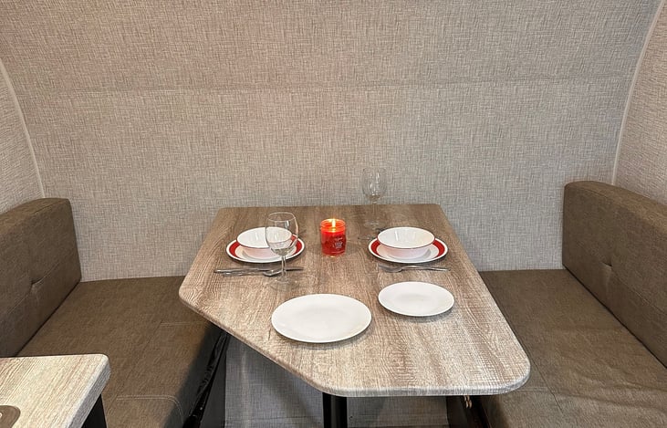 Roomy dinette for eating, playing games or meal prep. Table folds down to make an X-Large twin bed! Lots of storage space for extra blankets,  linen, towels and campfire supplies.