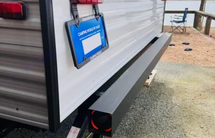 Stabilizer jacks to keep the movement to a minimum while walking around in the camper. Black/gray water dump hose conveniently stores in the bumper.