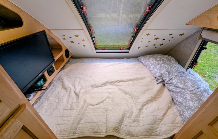 Cozy Queen bed nook with two windows, TV, stereo and storage cubbies will ensure you are comfortable and have everything you need for some rest and relaxation.