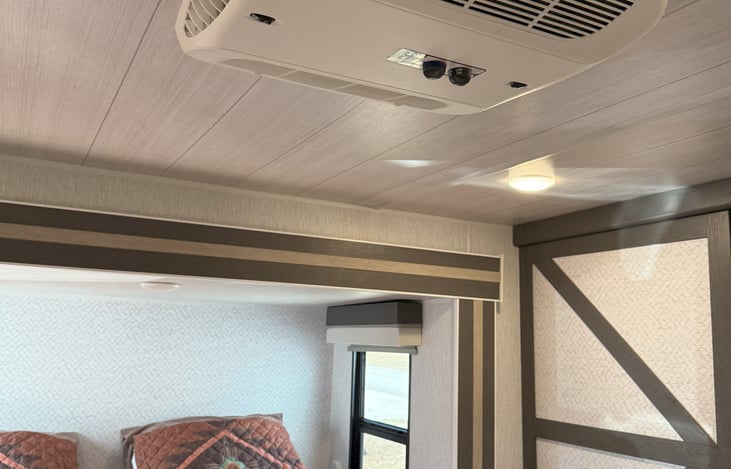 Separate, manually controlled A/C - heater in the bedroom.  Doesn't run off the main thermostat.