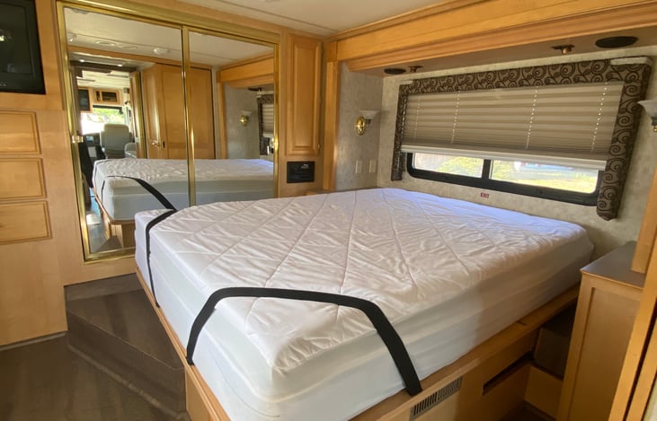 Queen mattress with mattress topper and mattress cover.