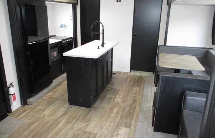 kitchen area, door to back bedroom and dinette