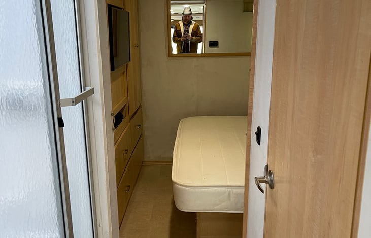 Master Bedroom shot from Hallway. Shower on the left. Bathroom on the right. FYI… that’s me in the mirror. The ceilings are not low. I’m just 6’7”, and yes I can stand up fully in the RV.