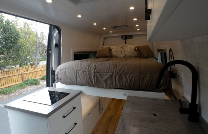 Rest easy after a day of adventure in our cozy, full-size power lift bed. Designed for ultimate comfort, it’s the perfect spot to unwind and recharge for the next day's journey. 🛏️✨ #CampervanComfort