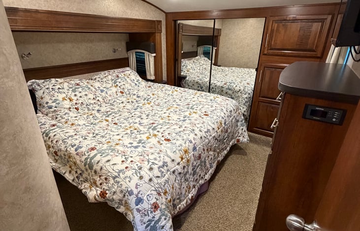 Main bedroom with KING bed, dresser, TV, closet and plenty of storage.