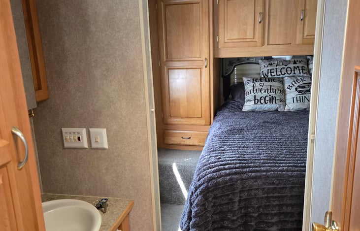 The mid area has the sink and a nice medicine cabinet and a private bathroom across the isle and the bedroom has a sliding door for privacy / seclusion