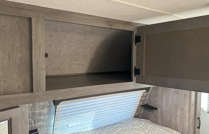 Extra storage above queen bed.
