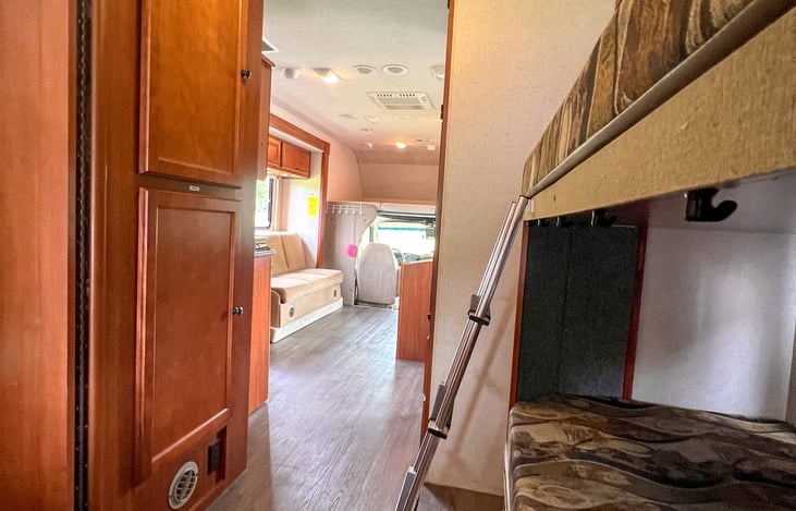 View to the front from the back bedroom.  The dual slide outs make this space feel large and super functional.  No need to trip over anyone.  Get your space when you need it.