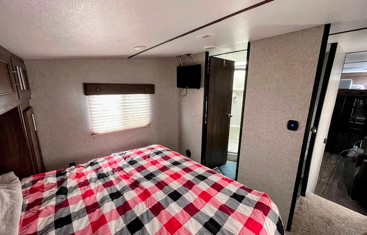 Main bedroom. Sleeps two adults comfortably. TV and walk in bathroom access for convenience.