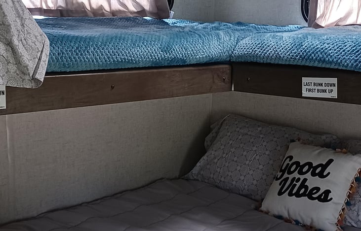 2 twin bunks overhead of a queen bed. Bunks can be lifted out of the way and bed can flip into a couch for seating