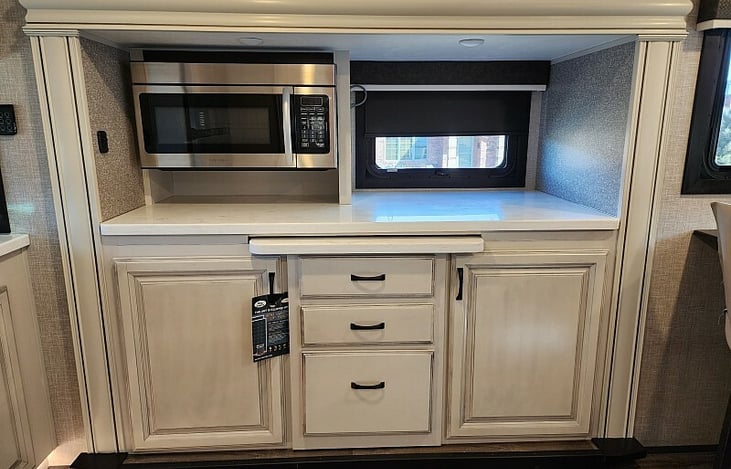 The middle section extends out about 2.5ft for extra cooking space and/or extra seating.