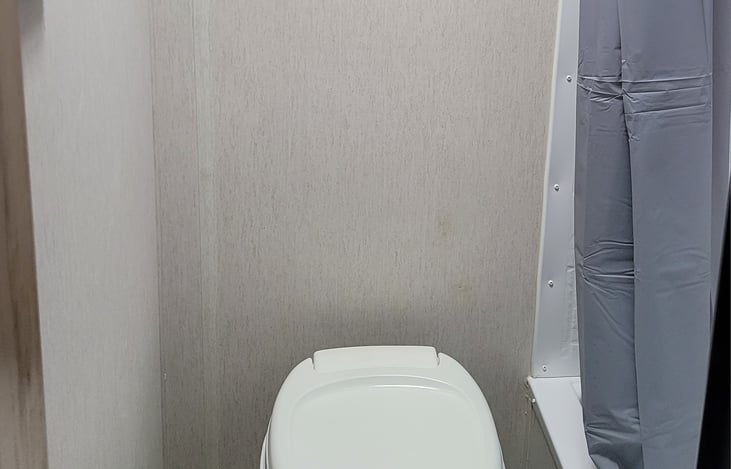 Bathroom sink is in shower.