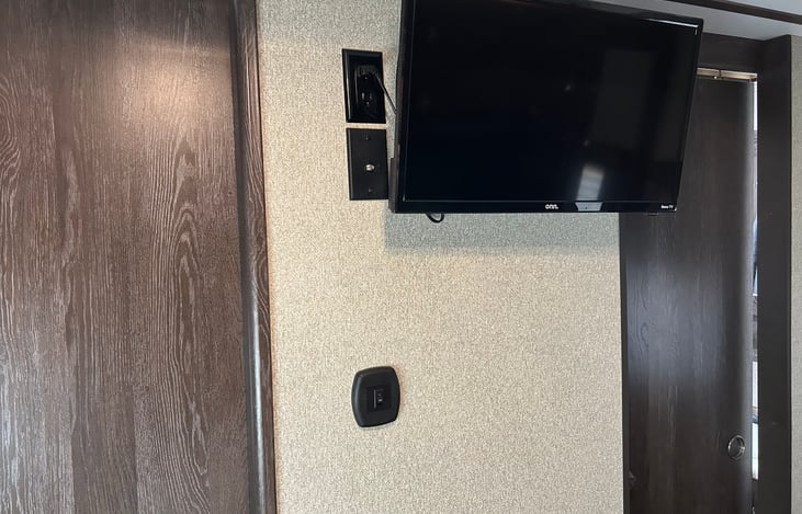 There is a TV in the master bedroom.