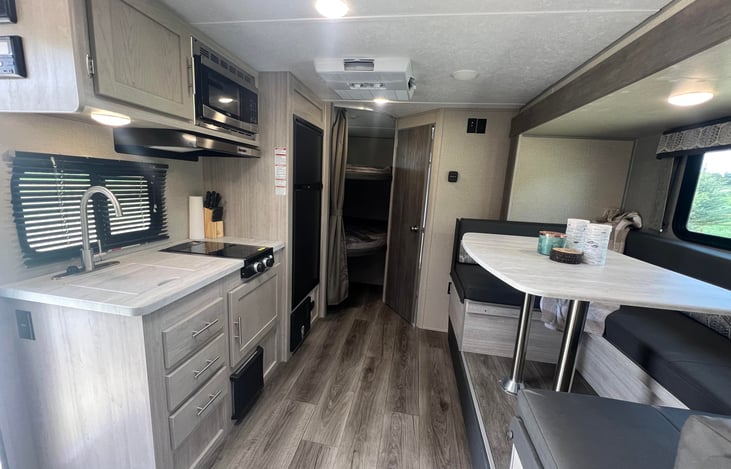 Big kitchen, with microwave, stove top, and sink! More storage and light.