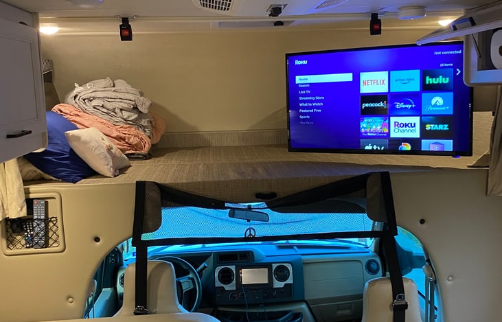 View of TV and full bed over cab