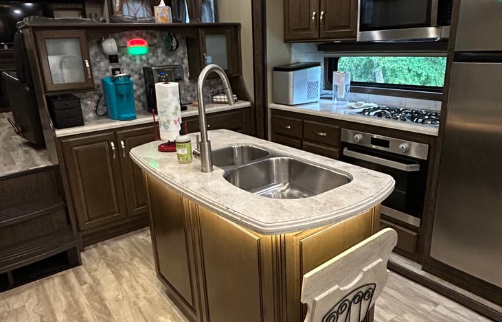 When you walk in the door, you walk into the kitchen.  There are stairs to the left that go into the living room and stairs to the right that go to the bathroom and bedroom.