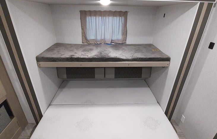 Rear bedroom (right side): Top bunk folded down, and sofa folded out into a queen size bed.