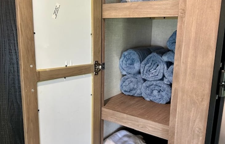 A designated storage space for neatly organizing towels and washcloths, ensuring they are easily accessible and kept in pristine condition.