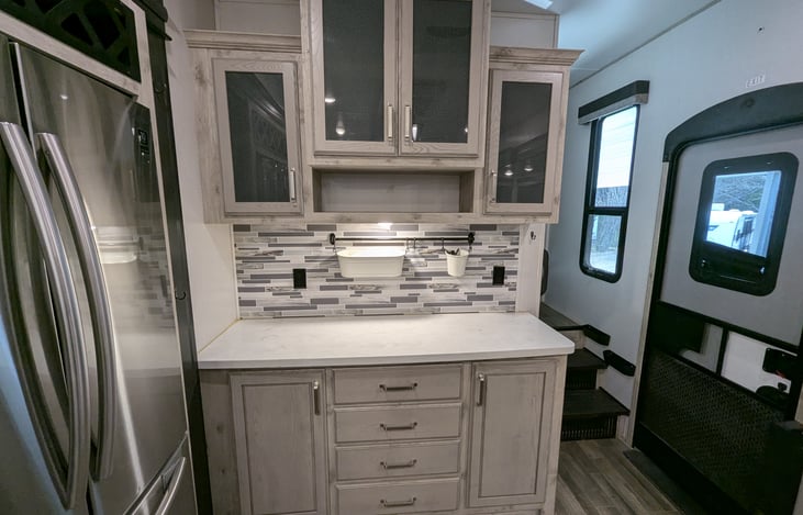 Chef’s dream galley! Features a massive 18 cu. ft. fridge, residential microwave, and 3-burner stove. Enjoy the solid-surface islands, deep sink, and pantry—perfect for feeding the whole crew.