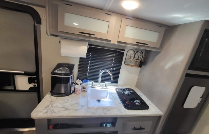 Kitchen has a two-burner gas stove and microwave. We have also added an ice maker and coffee pot (on table)