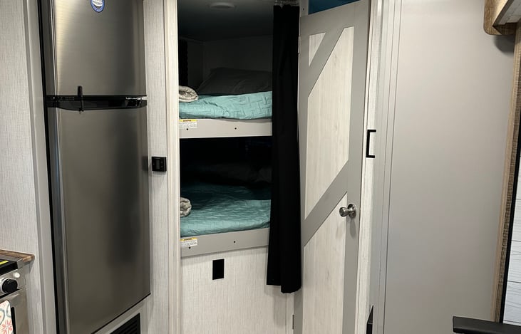 Two full-sized beds each stocked with two pillows, sheet, quilt, throw blanket. Can fit up to two people in each bed. Top bunk max weight 200+.