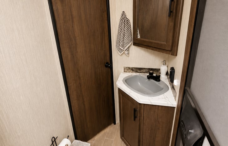 The 5 O’Clock Somewhere features a private bathroom with a toilet and shower, PLUS its own exterior entry/exit door—making bathroom access quick and convenient without walking through the entire RV!