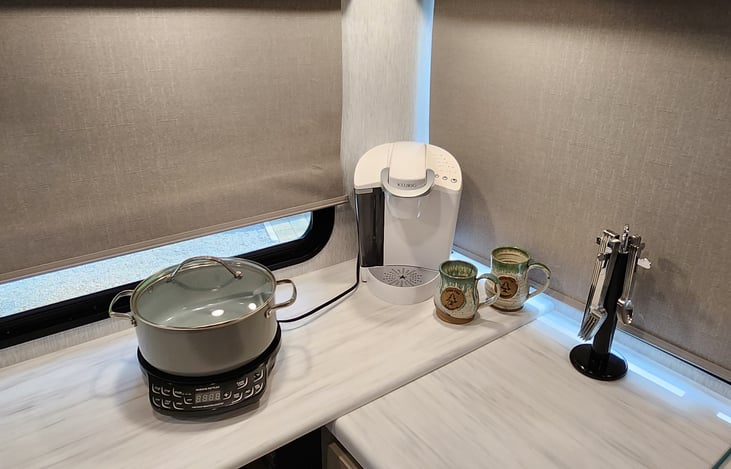 Keurig coffee maker, K-cups included.
Induction cooktop w/cookware. (doesn't heat up the inside of the camper)