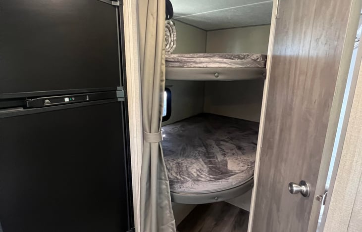 Double full bunks for the kids. Adults fit comfortably. Both top and bottom bunks have windows and charging ports.
