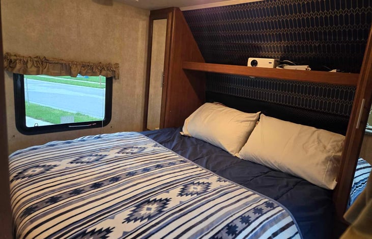 queen bed in the front of the rv