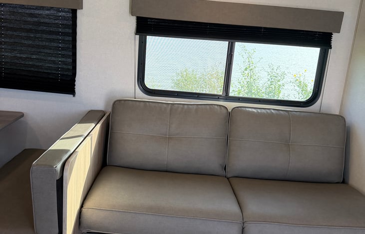 Comfortable dining dinette and living space—perfect for enjoying family meals, playing games, or relaxing after a day outdoors.