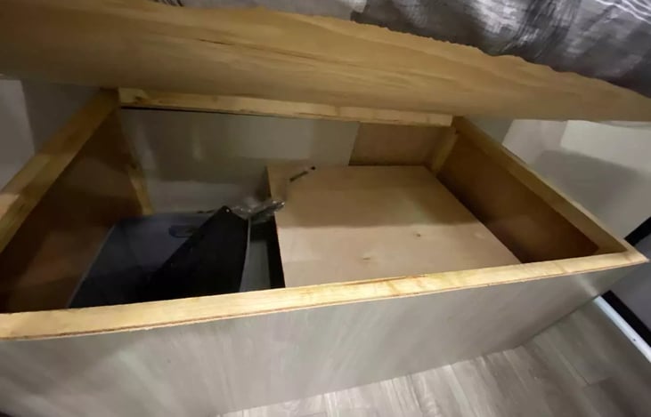 Storage under the bed which includes a spare tire.