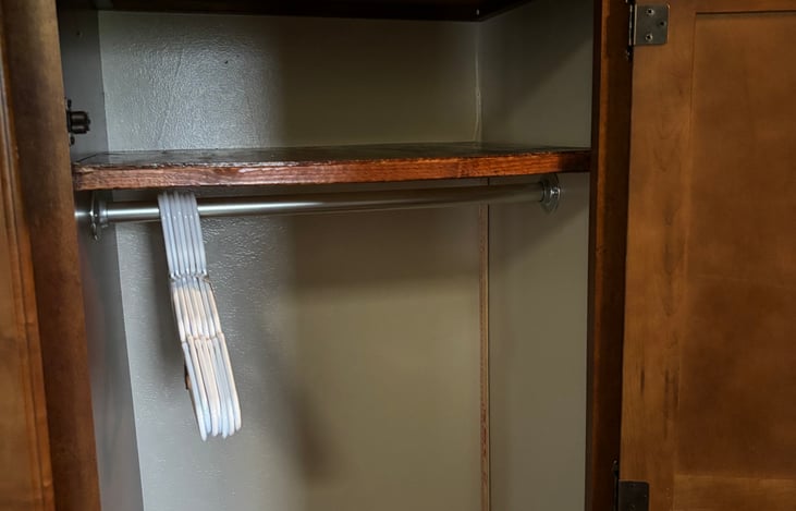 Closet in hallway for hanging clothes on one side and shelves on the other side, very roomy